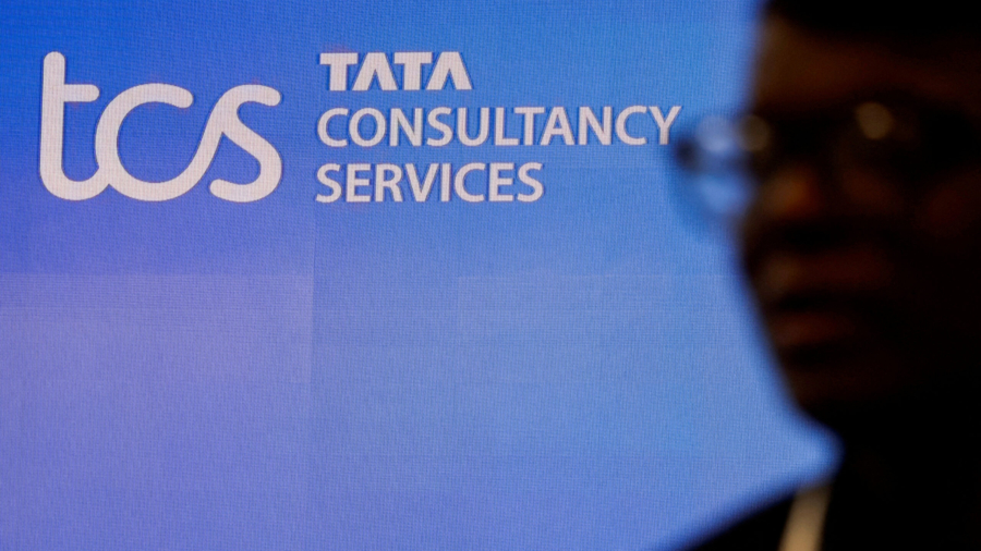 FILE PHOTO: A man walks past a logo of Tata Consultancy Services (TCS) before a press conference announcing the company's quarterly results in Mumbai, India, January 11, 2024. REUTERS/Francis Mascarenhas/File Photo